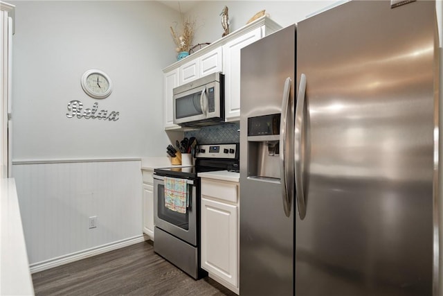 kitchen with white cabinets, dark hardwood / wood-style flooring, and appliances with stainless steel finishes