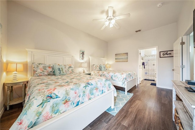 bedroom with ceiling fan, ensuite bathroom, and dark wood-type flooring