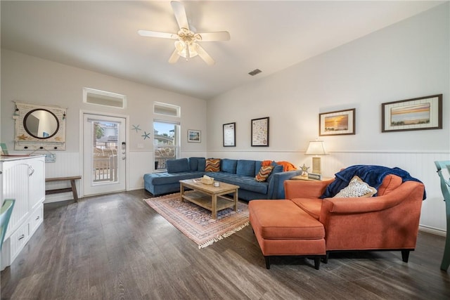 living room with ceiling fan and dark wood-type flooring