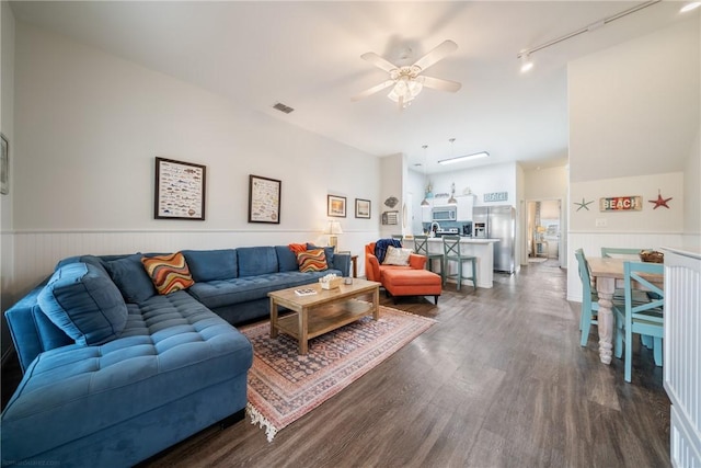 living room featuring ceiling fan, rail lighting, and dark hardwood / wood-style floors