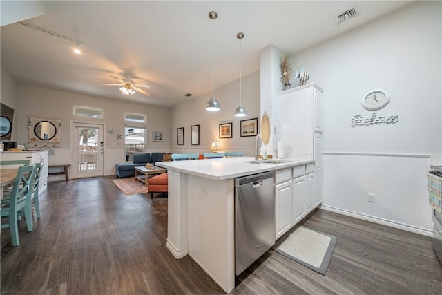 kitchen featuring kitchen peninsula, white cabinets, sink, pendant lighting, and dishwasher