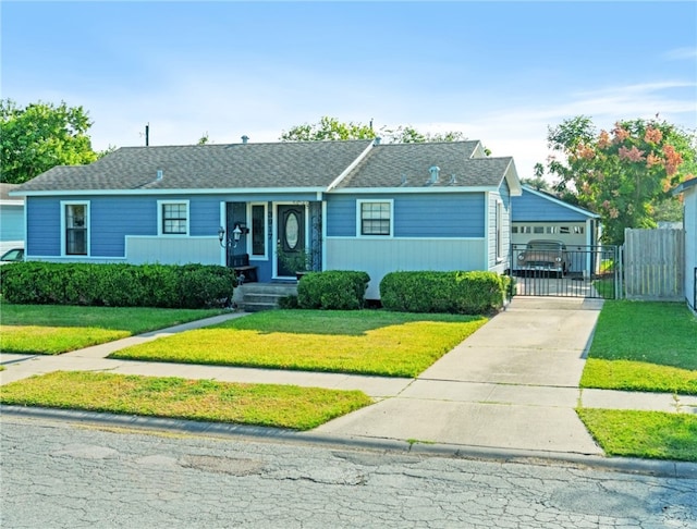 ranch-style home featuring a garage and a front lawn