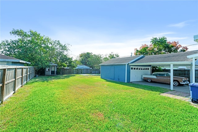 view of yard with a shed, a garage, and a carport