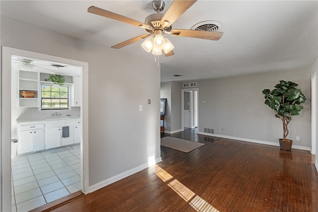 unfurnished room featuring light hardwood / wood-style floors and ceiling fan