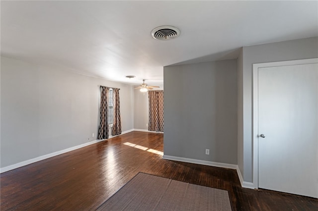 spare room featuring ceiling fan and dark hardwood / wood-style flooring