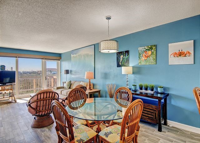 dining space with light wood-type flooring and a textured ceiling