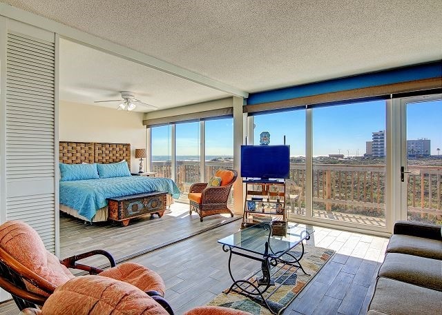 bedroom featuring a textured ceiling, wood-type flooring, ceiling fan, and beam ceiling