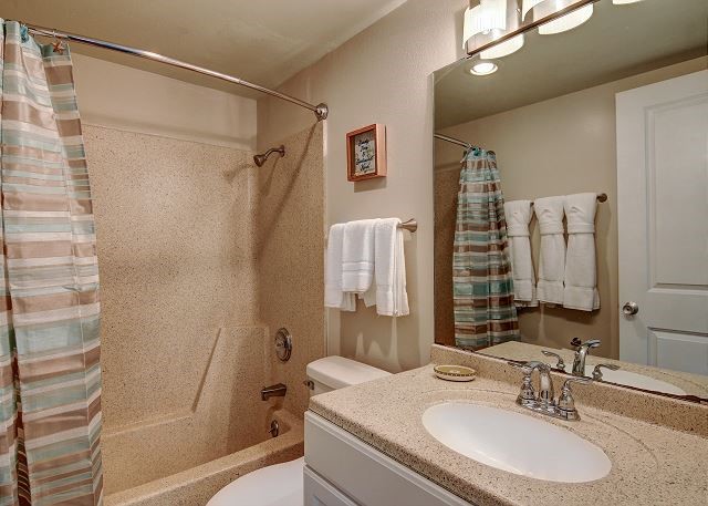 full bathroom featuring vanity, shower / bath combination with curtain, and toilet