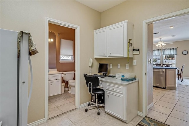 home office with ceiling fan, built in desk, light tile patterned floors, and baseboards