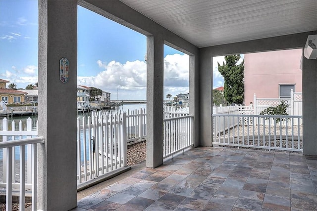 balcony featuring a water view and a patio