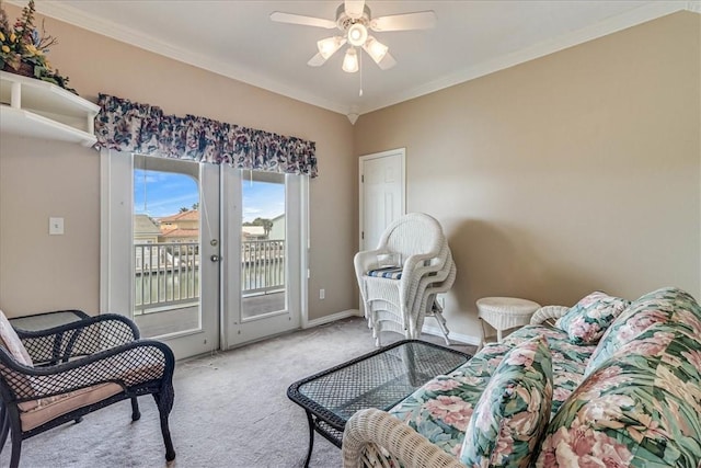 carpeted living room with ornamental molding, french doors, baseboards, and a ceiling fan