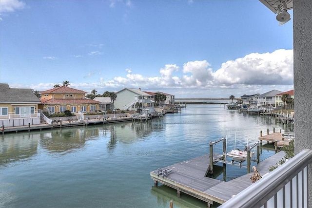 view of dock featuring a water view and a residential view