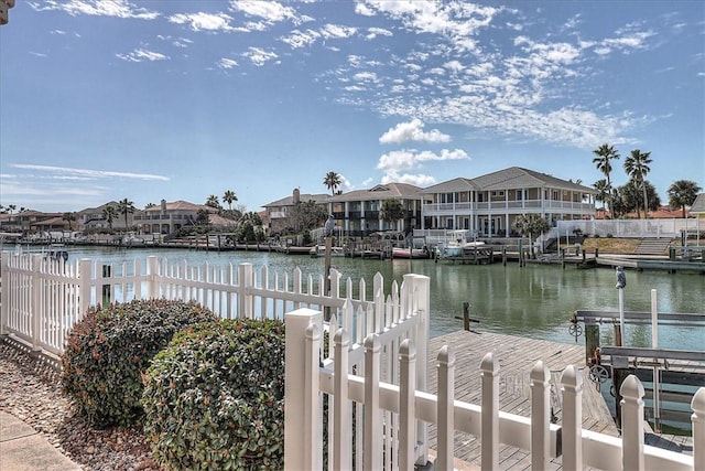 view of dock featuring a water view and a residential view