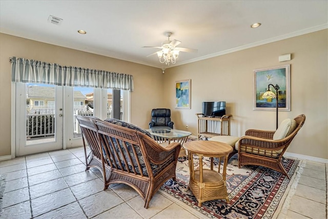 living area with crown molding, light tile patterned floors, visible vents, ceiling fan, and baseboards