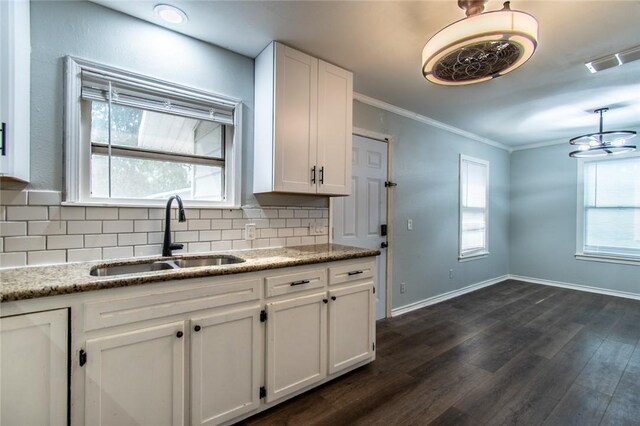 4001 Cott St, Corpus Christi, TX 78411 - kitchen with a sink, decorative backsplash, white cabinetry, ornamental molding, and plenty of natural light