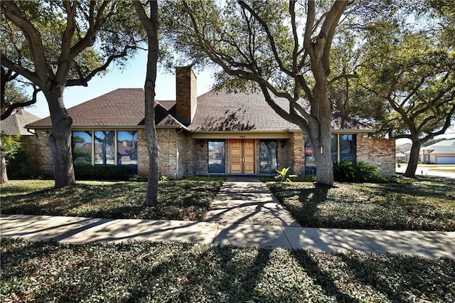 view of front of home featuring a chimney