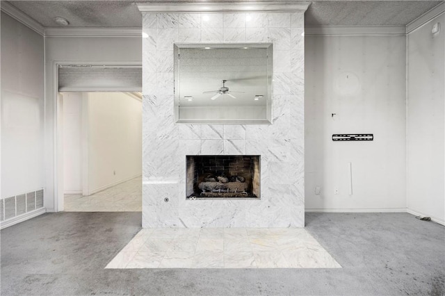 unfurnished living room featuring a textured ceiling, light colored carpet, visible vents, ornamental molding, and a tiled fireplace