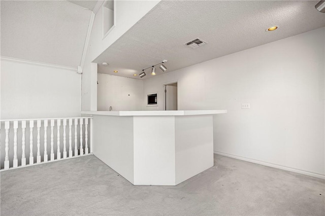 bar with light carpet, visible vents, and a textured ceiling