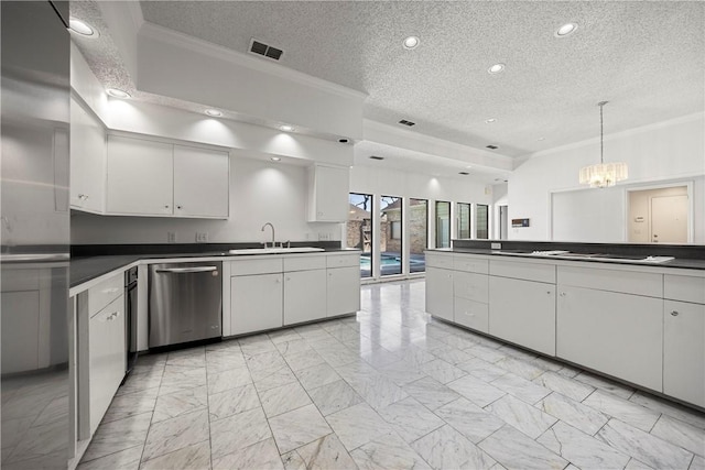 kitchen featuring white cabinets, dark countertops, decorative light fixtures, a sink, and stainless steel dishwasher