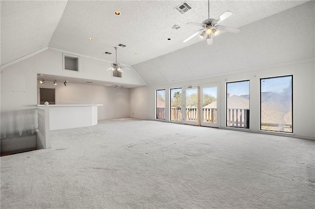 unfurnished living room featuring lofted ceiling, visible vents, and light colored carpet