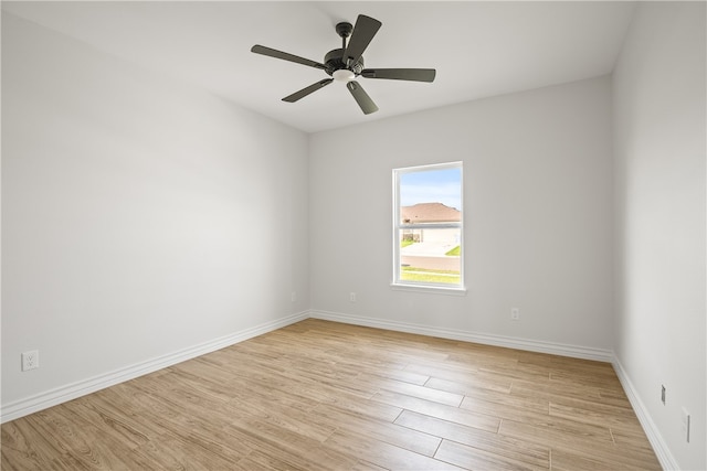 spare room with light wood-type flooring and ceiling fan