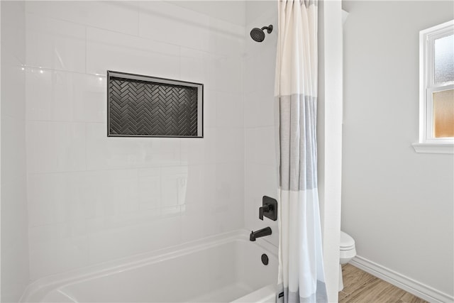 bathroom featuring toilet, shower / bath combo, and hardwood / wood-style flooring