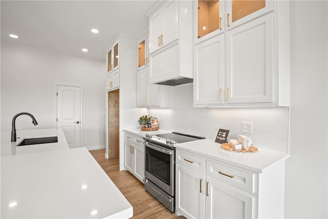 kitchen with white cabinetry, light hardwood / wood-style flooring, sink, and electric range