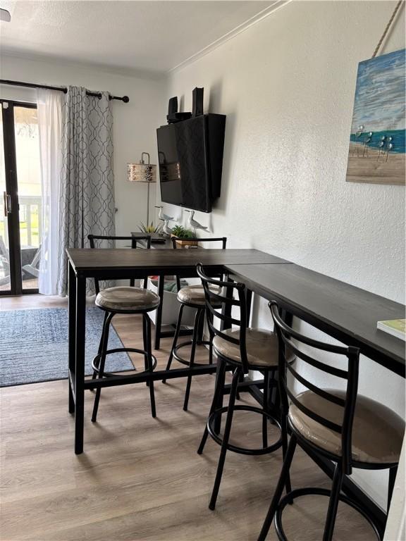 3938 Surfside Blvd Unit 3129, Corpus Christi, TX 78402 - dining space with a textured wall and wood finished floors