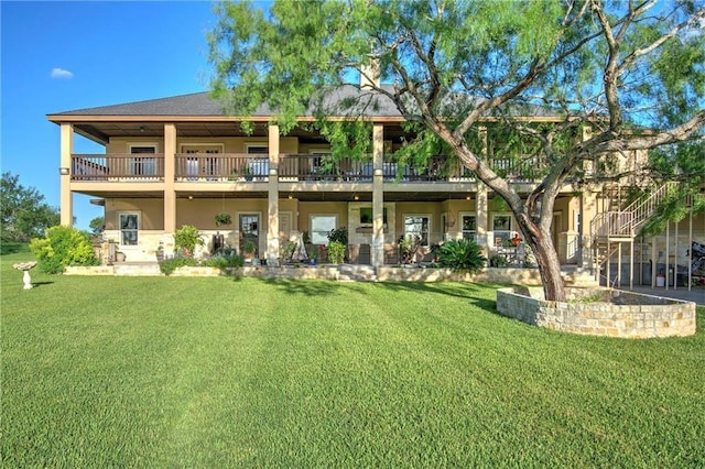 rear view of property with a yard