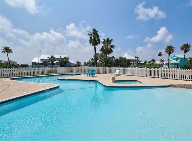 view of pool with a patio area and an in ground hot tub