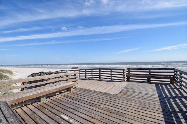 deck with a view of the beach and a water view