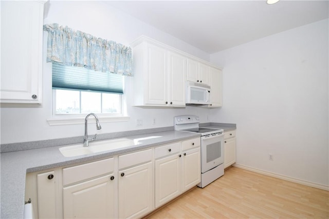 kitchen featuring white cabinets, white appliances, sink, and light hardwood / wood-style flooring