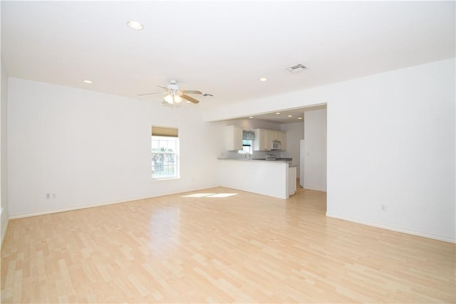 unfurnished living room featuring light hardwood / wood-style flooring and ceiling fan