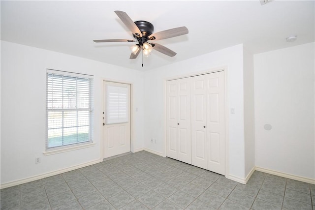 interior space with ceiling fan and light tile patterned floors