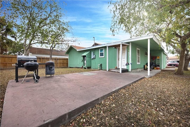 back of property with a carport