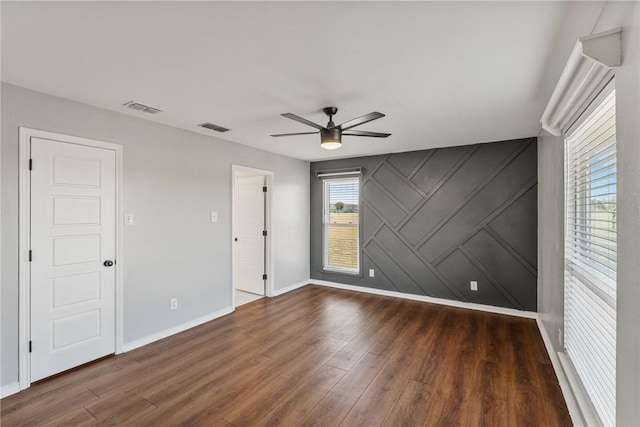 spare room featuring ceiling fan and dark hardwood / wood-style flooring