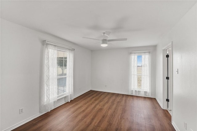 empty room with ceiling fan and dark wood-type flooring