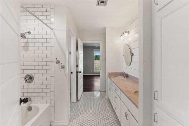 bathroom with vanity, tiled shower / bath combo, and tile patterned floors