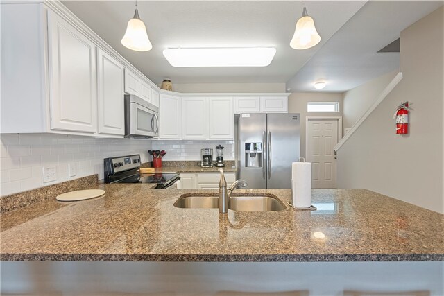 kitchen featuring sink, appliances with stainless steel finishes, decorative light fixtures, and white cabinets