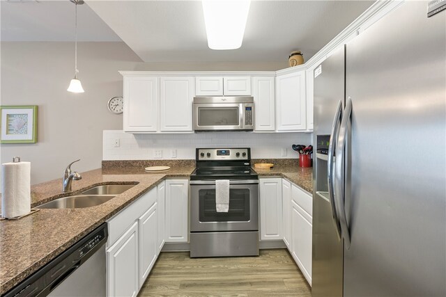 kitchen featuring white cabinetry, stainless steel appliances, sink, and light hardwood / wood-style flooring