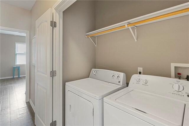 washroom featuring washing machine and dryer and hardwood / wood-style floors