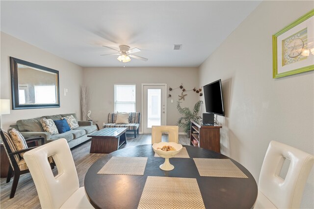 dining space featuring hardwood / wood-style flooring and ceiling fan