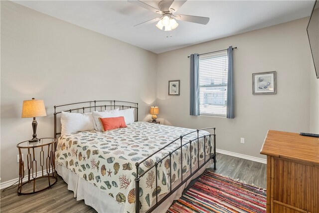 bedroom featuring ceiling fan and dark hardwood / wood-style floors