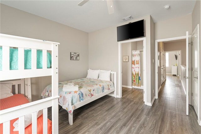 bedroom with dark hardwood / wood-style flooring and ceiling fan