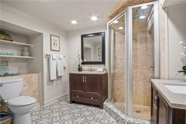 bathroom featuring vanity, a shower with door, and toilet