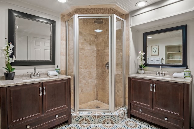 bathroom with vanity, an enclosed shower, and tile patterned flooring