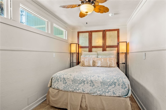 bedroom featuring multiple windows, crown molding, and ceiling fan