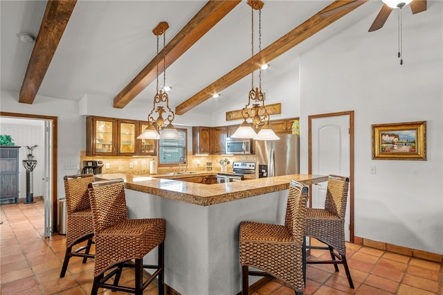 kitchen featuring appliances with stainless steel finishes, sink, a breakfast bar area, backsplash, and kitchen peninsula