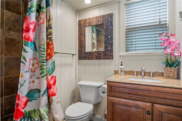 bathroom with vanity, toilet, and walk in shower