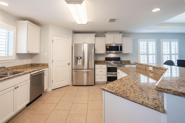 kitchen featuring a healthy amount of sunlight, white cabinets, visible vents, and appliances with stainless steel finishes